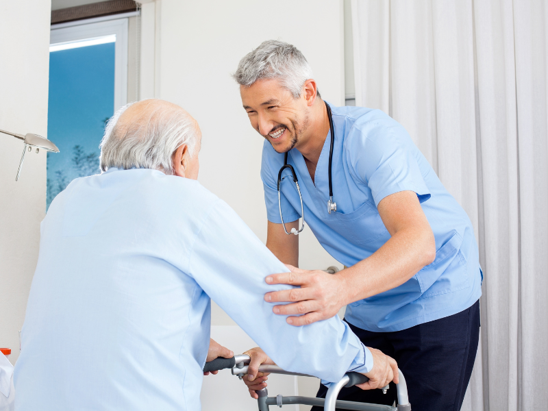 man lifting up elderly