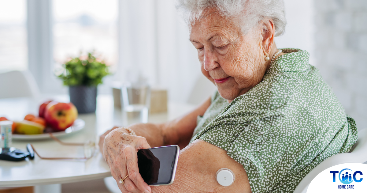 A senior woman uses her smartphone to check her glucose monitor, a tool that can be extremely helpful for diabetes care.