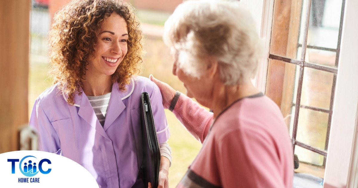 A happy caregiver enters the home of a client, representing in-home recovery care.