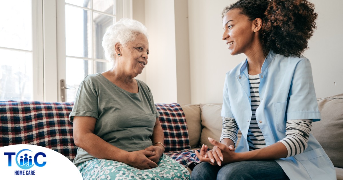 A caregiver sits and spends time with a client, representing how non-medical home care can benefit older loved ones.