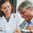 A woman smiles while with clients showing how you can enjoy senior caregiver jobs.