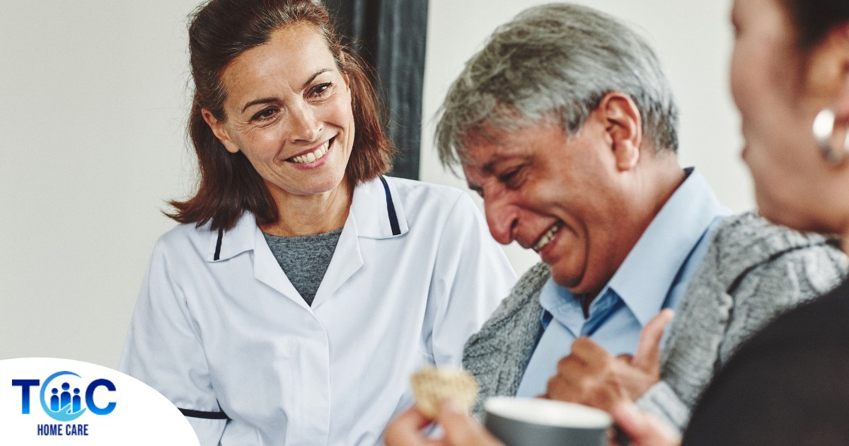 A woman smiles while with clients showing how you can enjoy senior caregiver jobs.