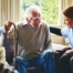 A woman has a good time with her older clients, representing the kind of personal skills needed to be a good caregiver.