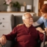 A caregiver helping a woman with a walker make her senior home safer.